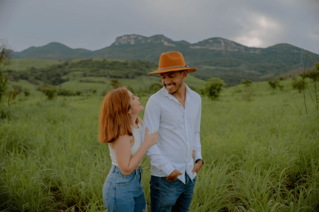 Happy couple walking through the field