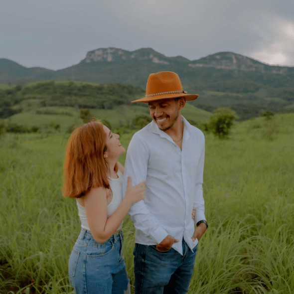 Happy couple walking through the field