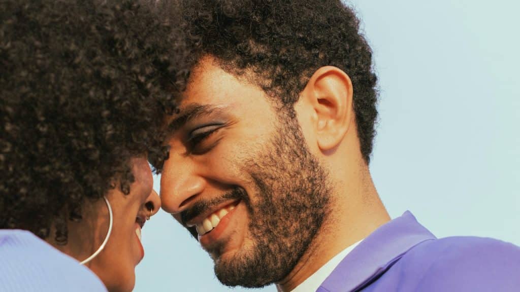 A smiling couple touching foreheads.