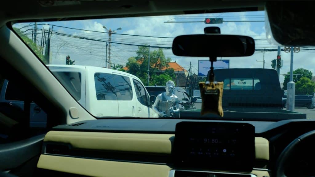 View from inside a car at a traffic signal.