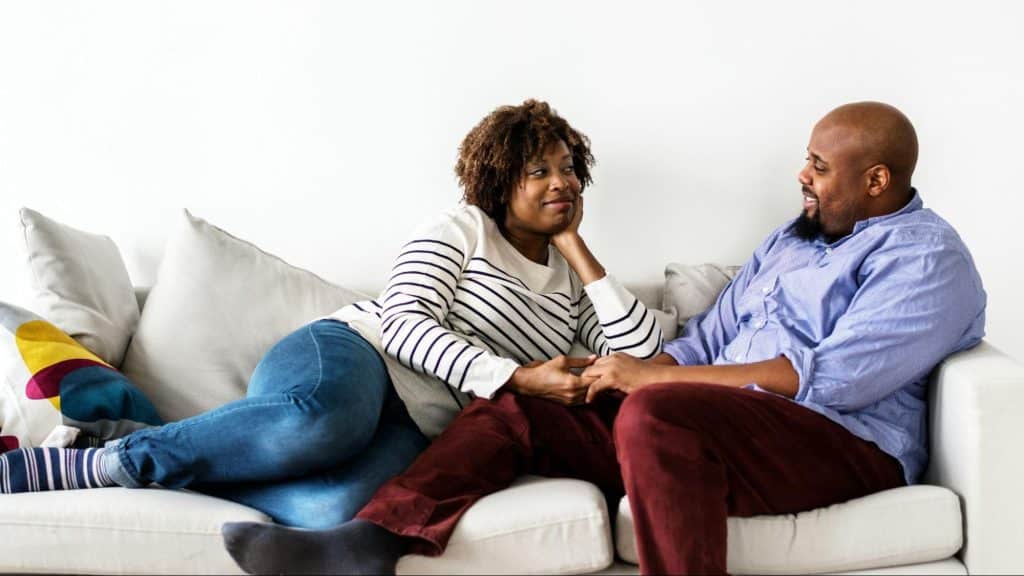A man and woman sitting at the couch