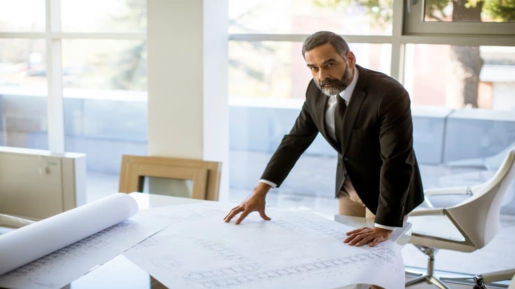 A man checking blueprints in the office