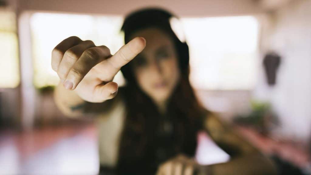 A person reaching toward the camera with a hand in focus.
