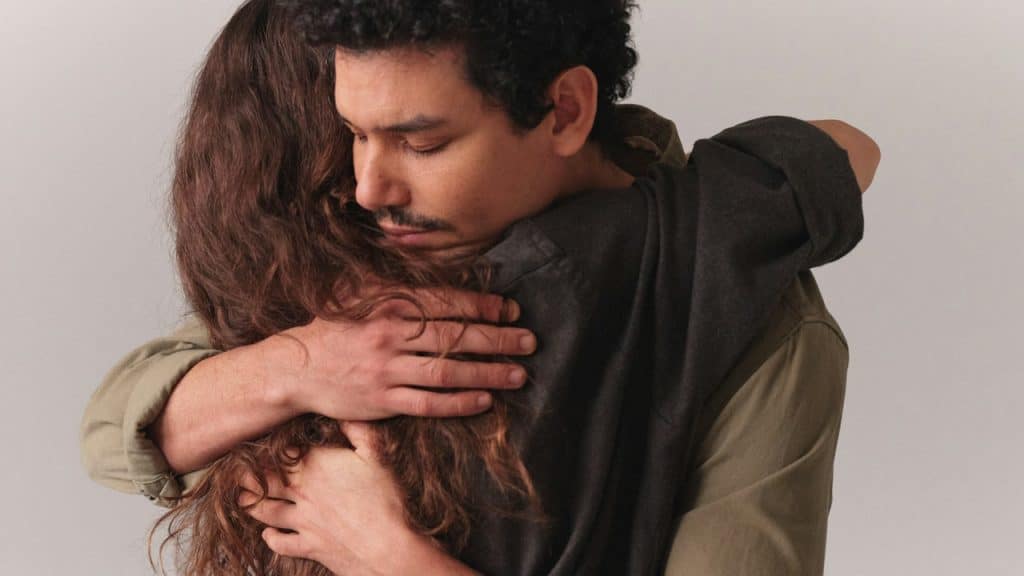 A man and a woman embracing each other.