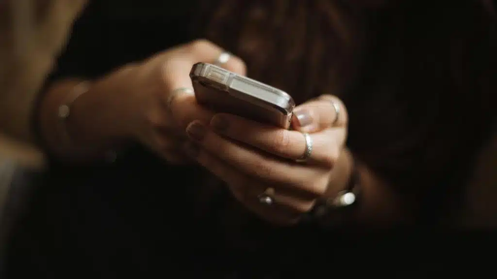 A close-up of hands holding a smartphone.