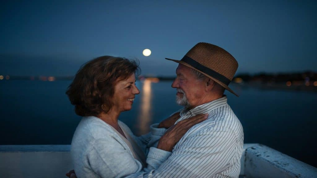 An older couple dancing under the moonlight