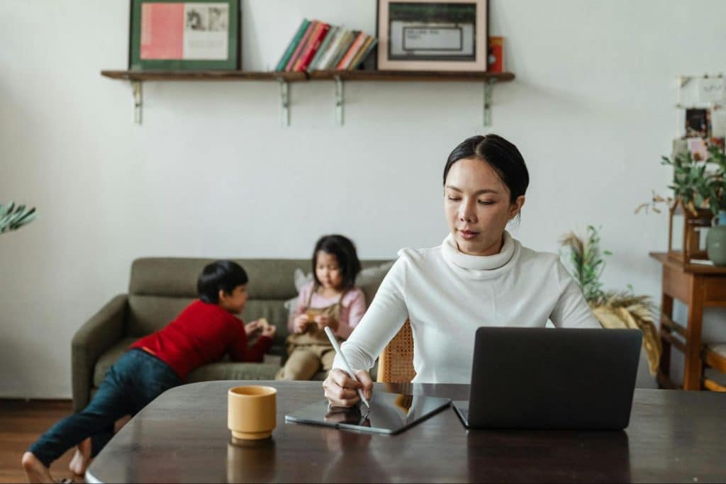Woman taking care of children while working