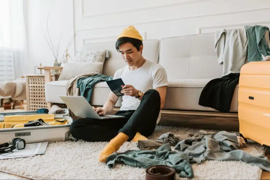 A man sitting on the floor with a mess around him