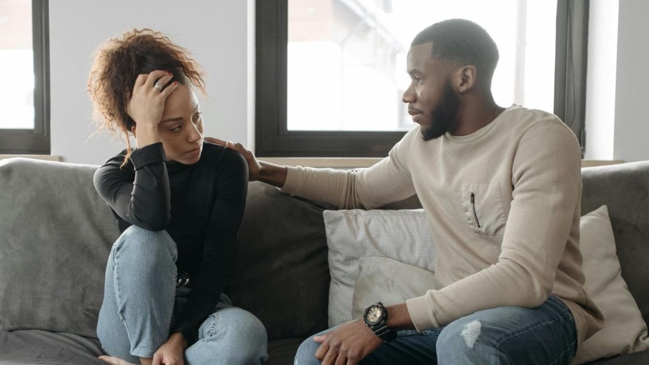 A man and woman sitting at the sofa