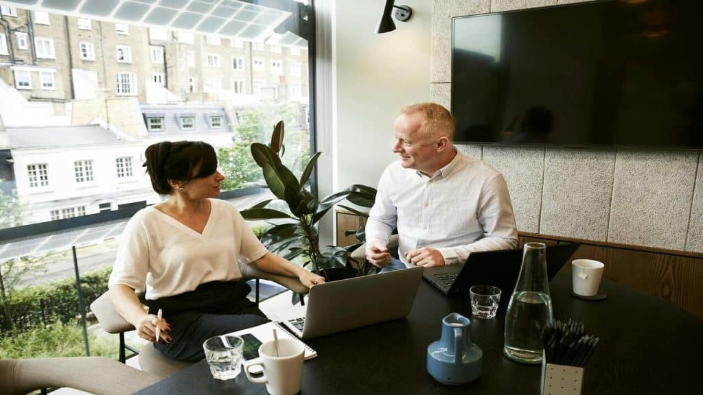 A man and a woman at a meeting