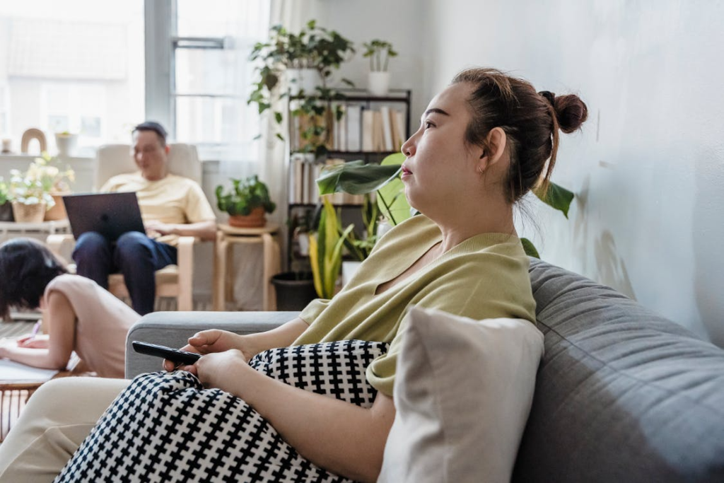 A Woman Sitting on a Couch Across from Man
