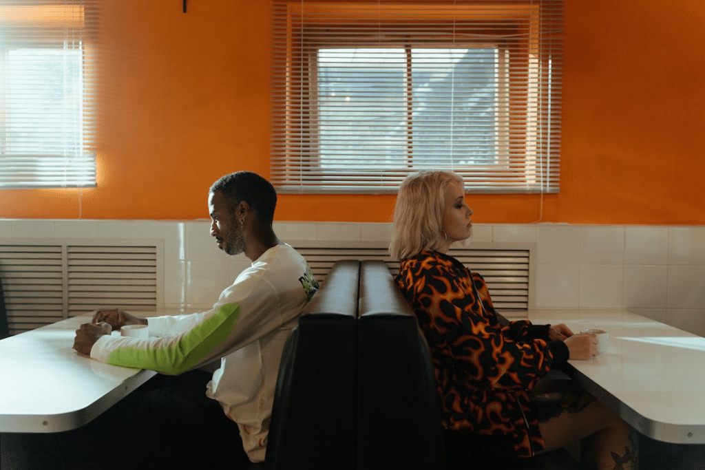 Man and Woman Sitting Back To Back Having A Fight