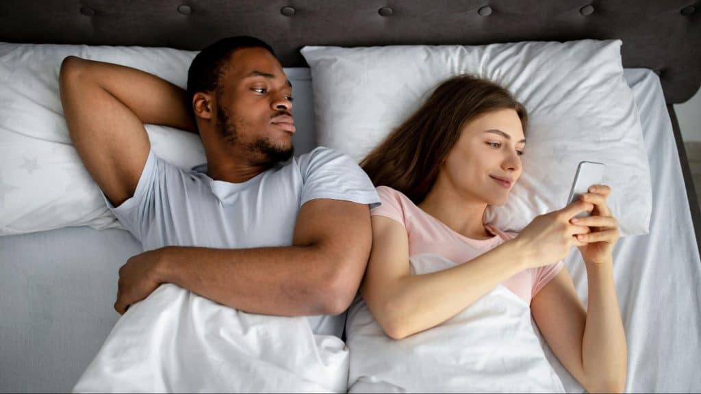 A man just watching a woman using a phone