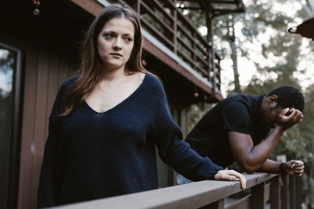 Unhappy couple leaning on railing