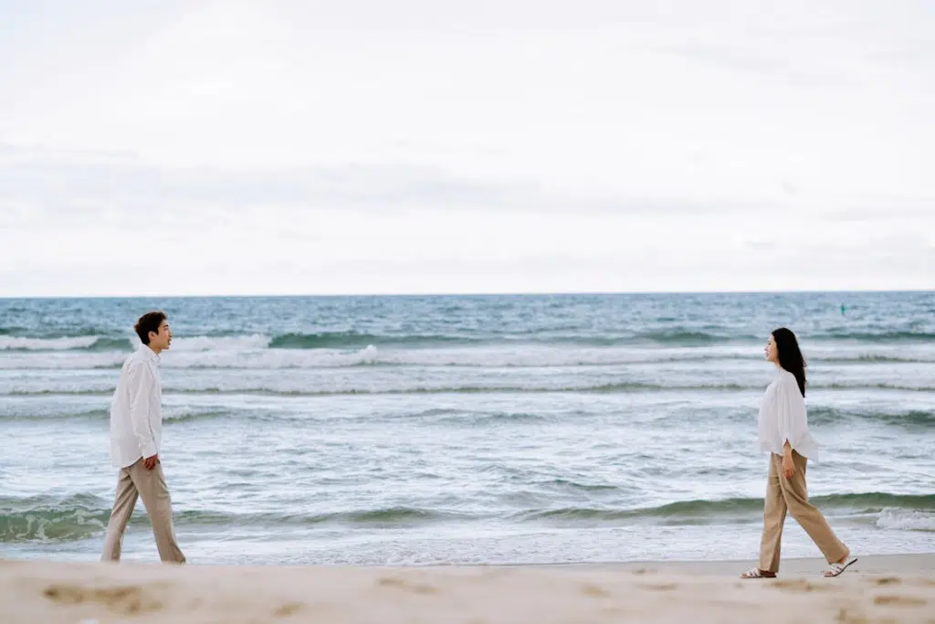 Man and Woman Walking on Beach