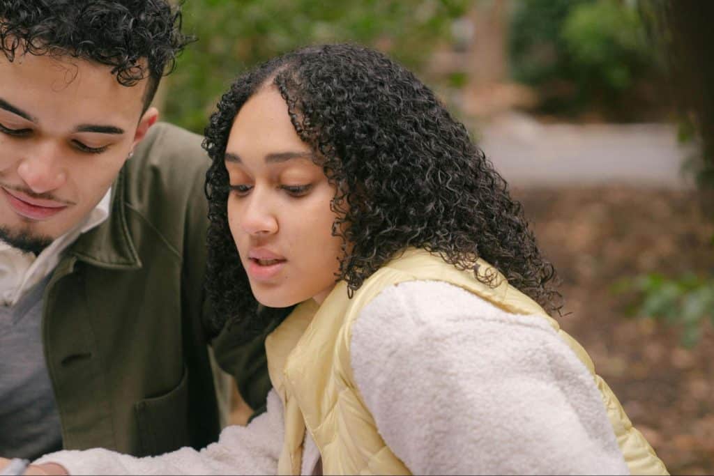 Woman checking man’s phone