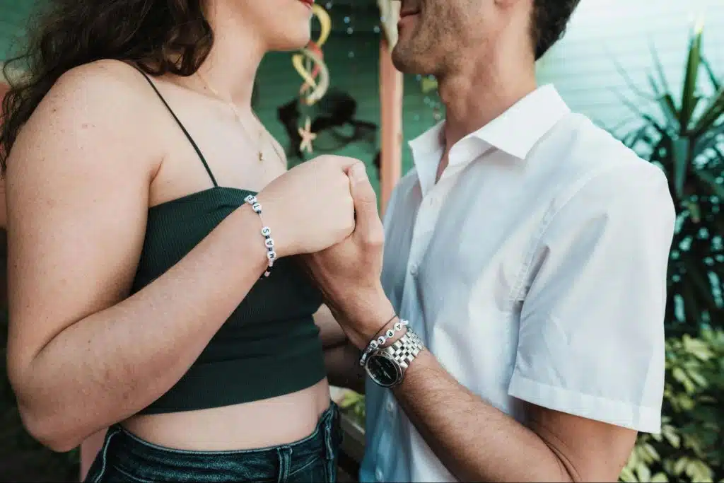 A man holding woman’s hand