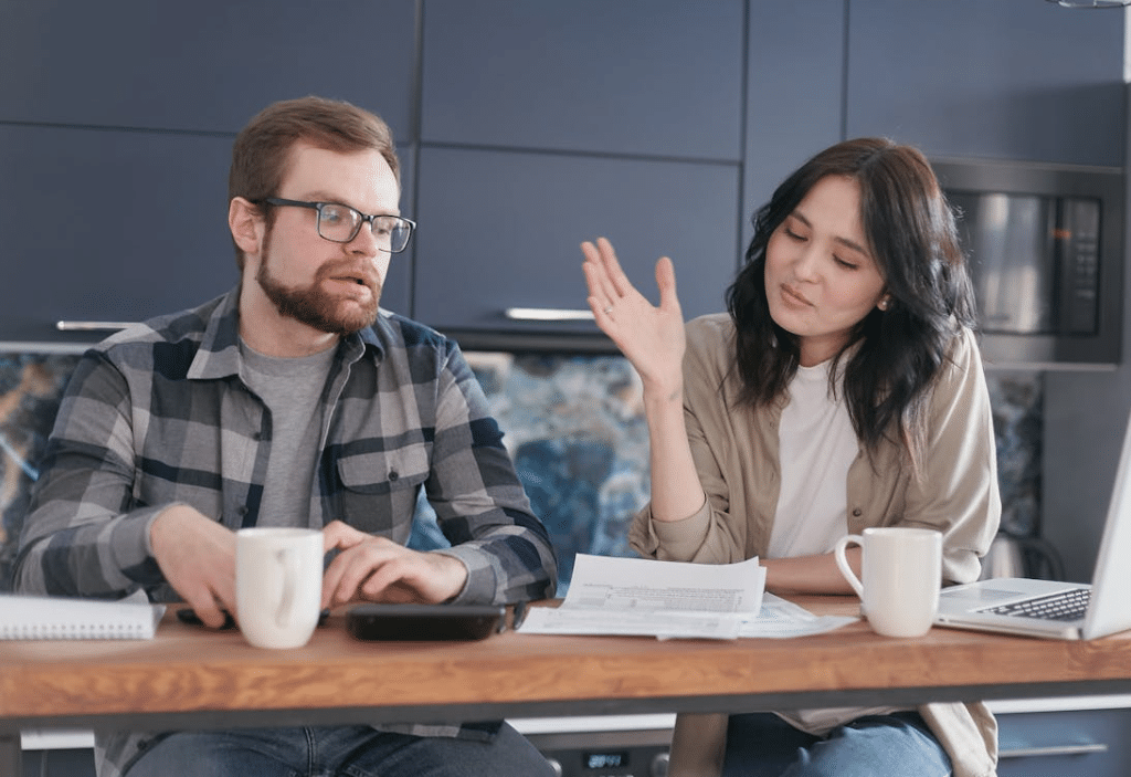 Couple Sitting at table with Papers