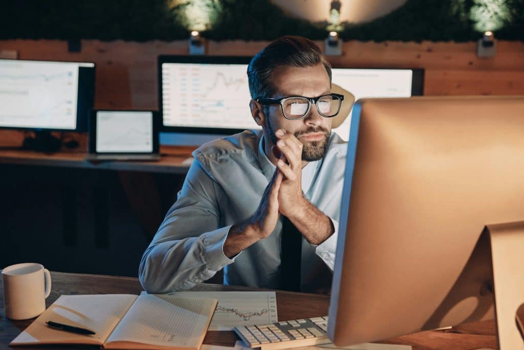 Alt text: man focused laptop night