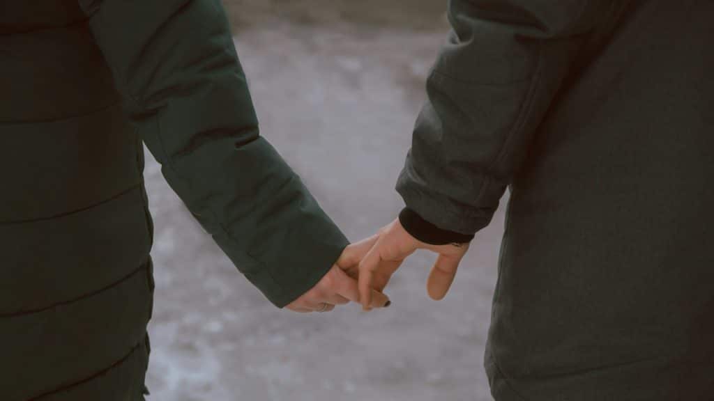 A couple holding hands.