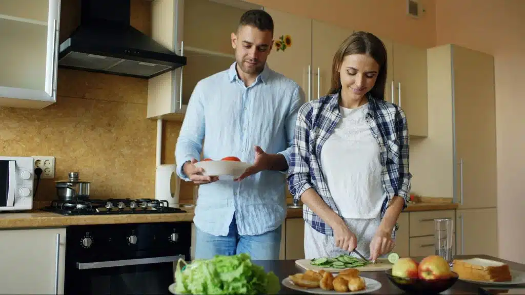 A man helping a woman at the kitchen