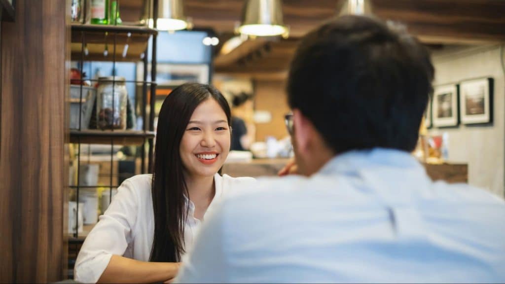Woman smiling to a man