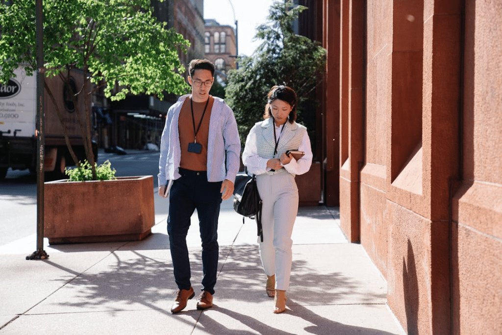 Man and Woman Walking on Sidewalk