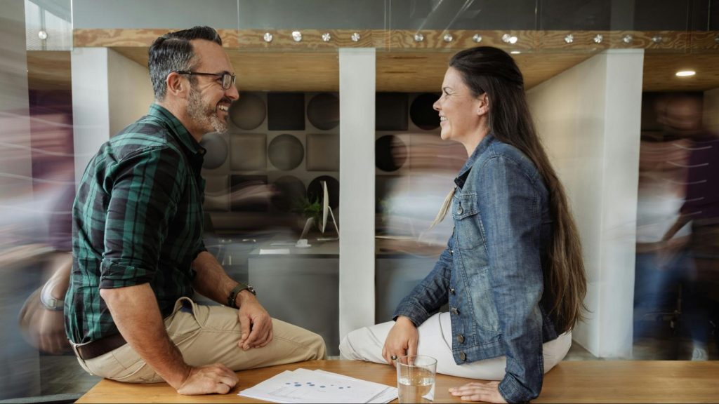 A man and woman smiling at each other