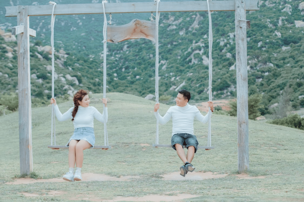 Couple having fun on swings