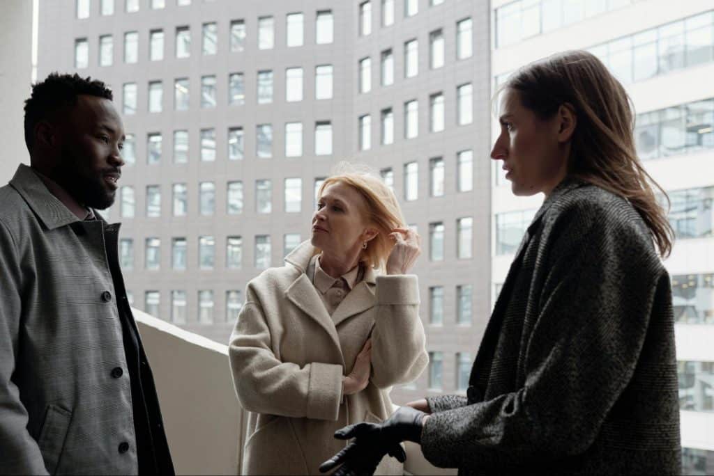 Woman thinking in front of her colleagues