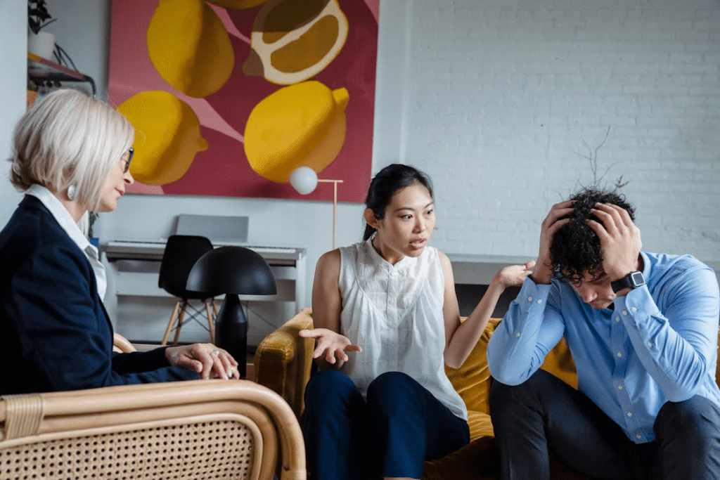 Couple discussing problems during session with psychologist