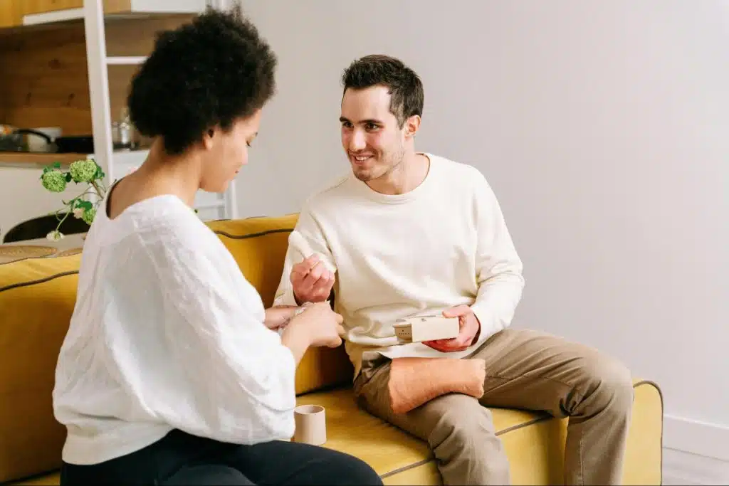 A man smiling to woman