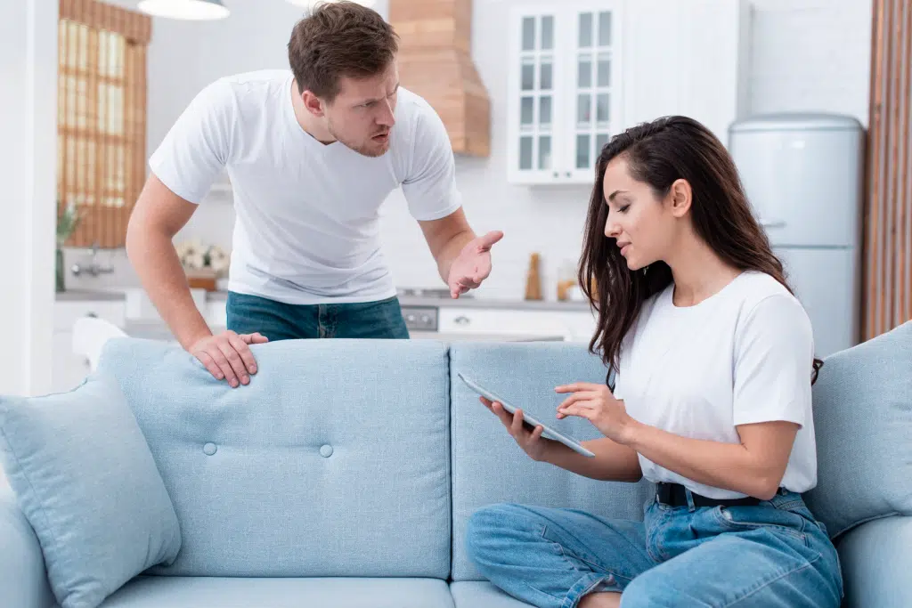 Couple on couch with different body languages