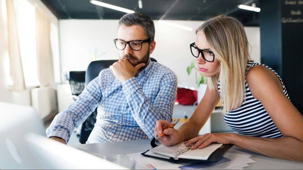A man keeping and woman checking something