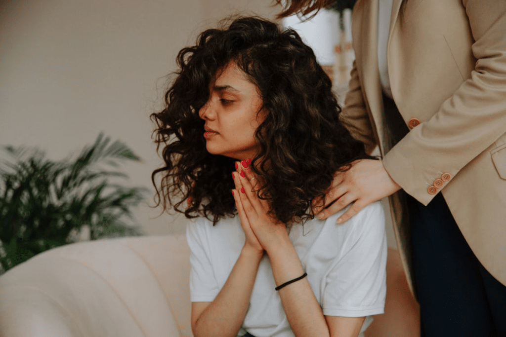 Sorrowful woman being comforted