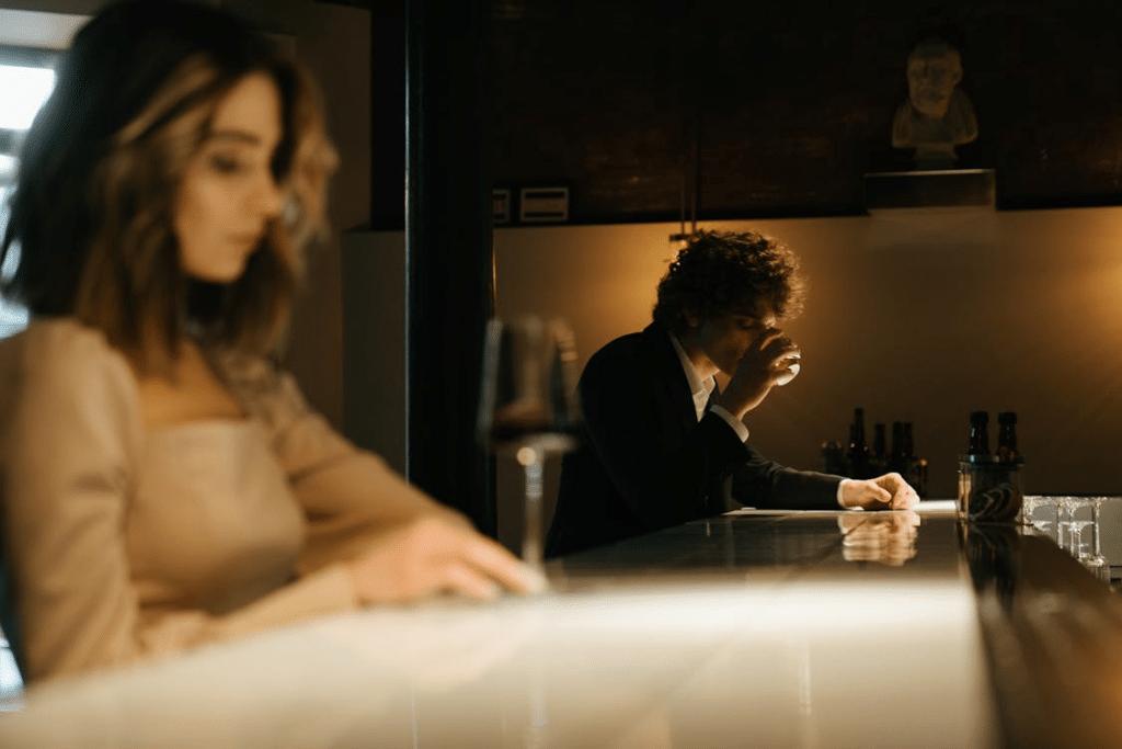 Couple at different tables drinking apart from each other