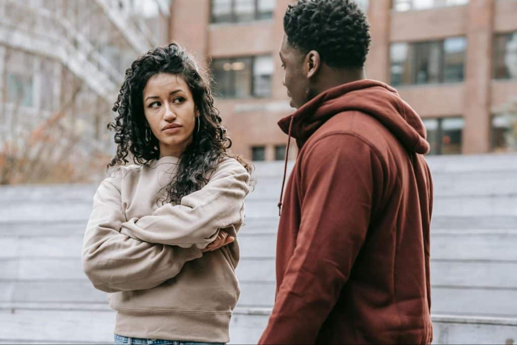 A woman looking at the man