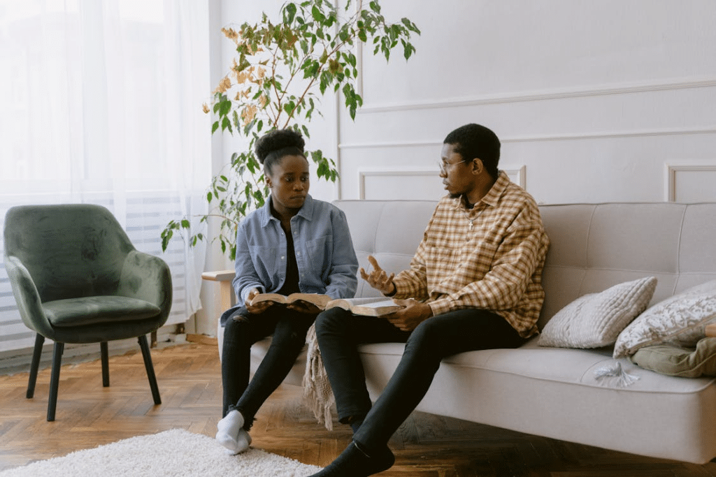 Couple having serious discussion sitting on the couch
