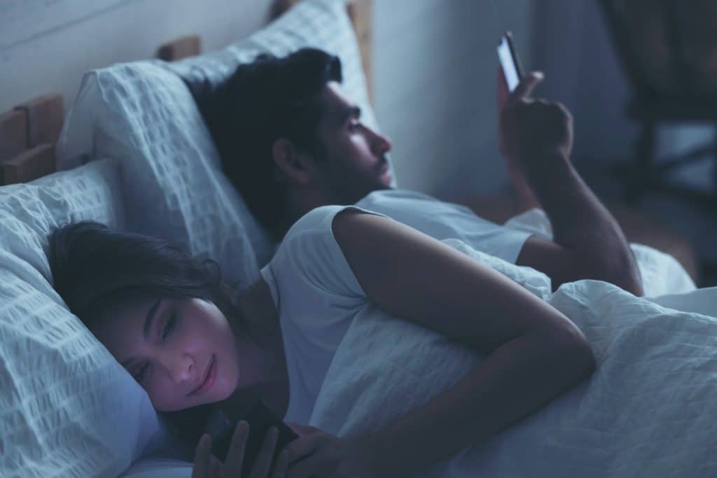 couple texting phones