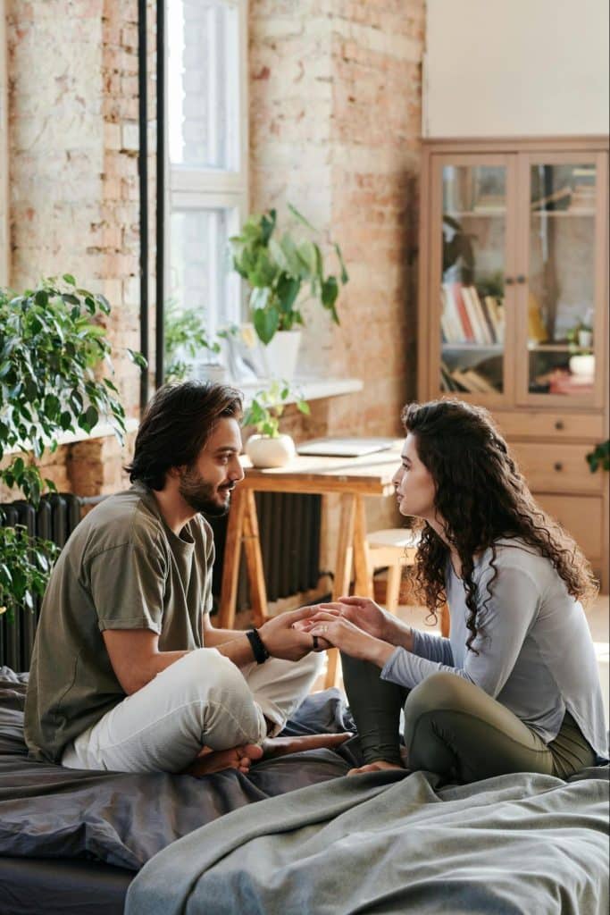 A couple holding hands while talking