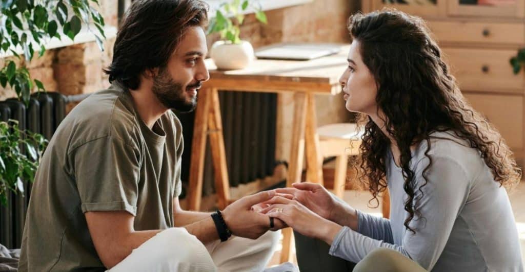 A couple holding hands while talking