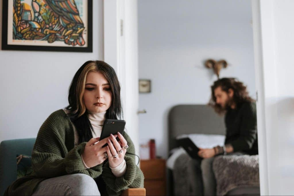 A couple at home using gadgets