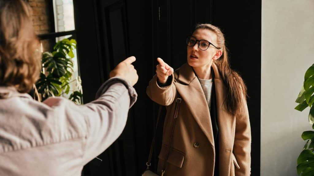 A woman pointing her finger during a tense conversation.