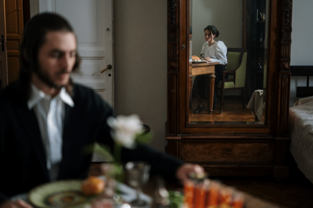 Man and Woman Sitting On Wooden Chair
