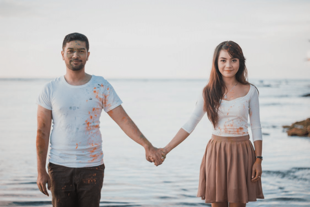Couple Holding Hands near Water