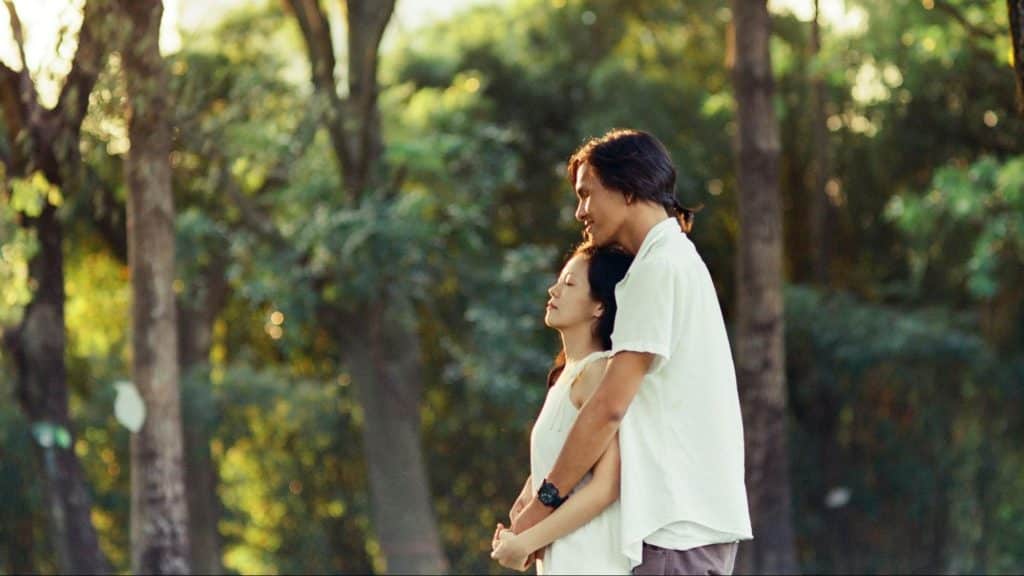 A man hugging a woman from behind
