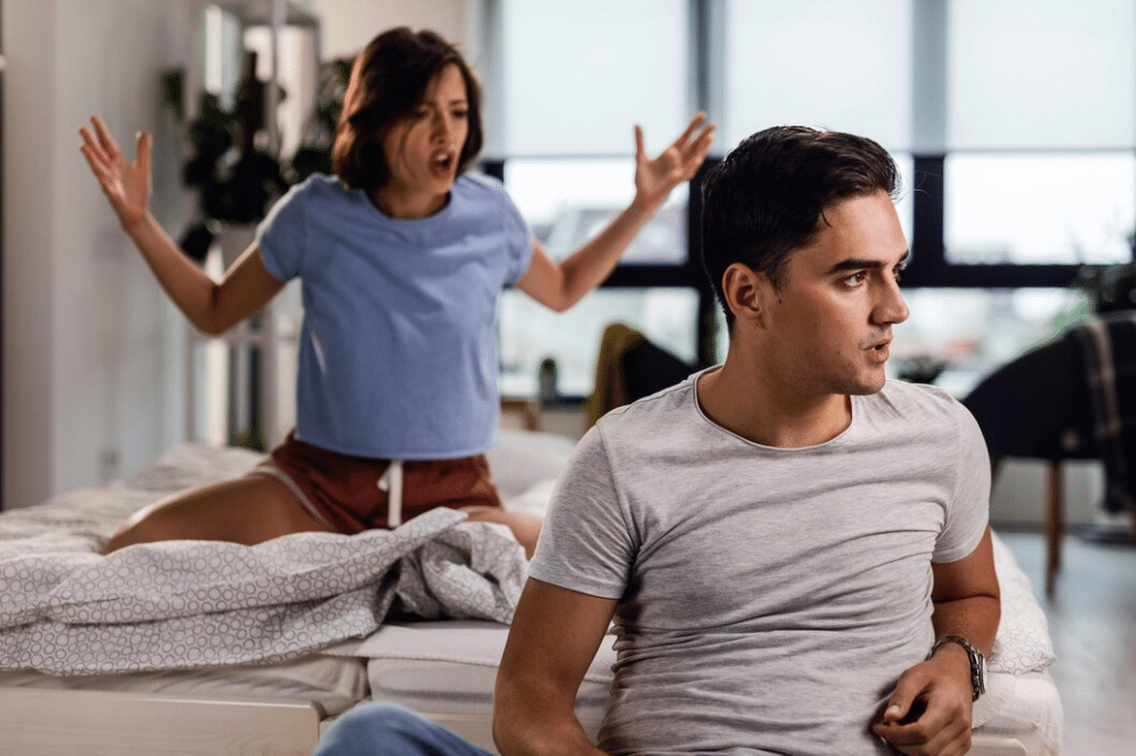 Young couple having a fight in the bedroom