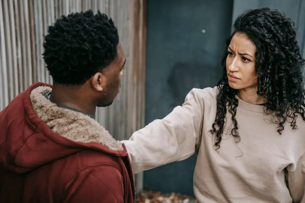Unhappy multiethnic couple on street