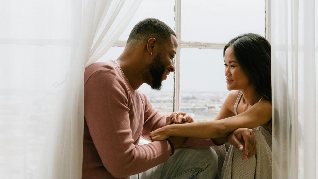 A man and woman smiling to each other