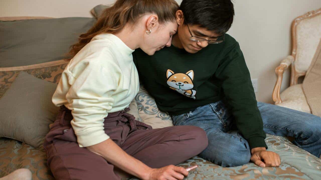 A couple looking sad on the couch